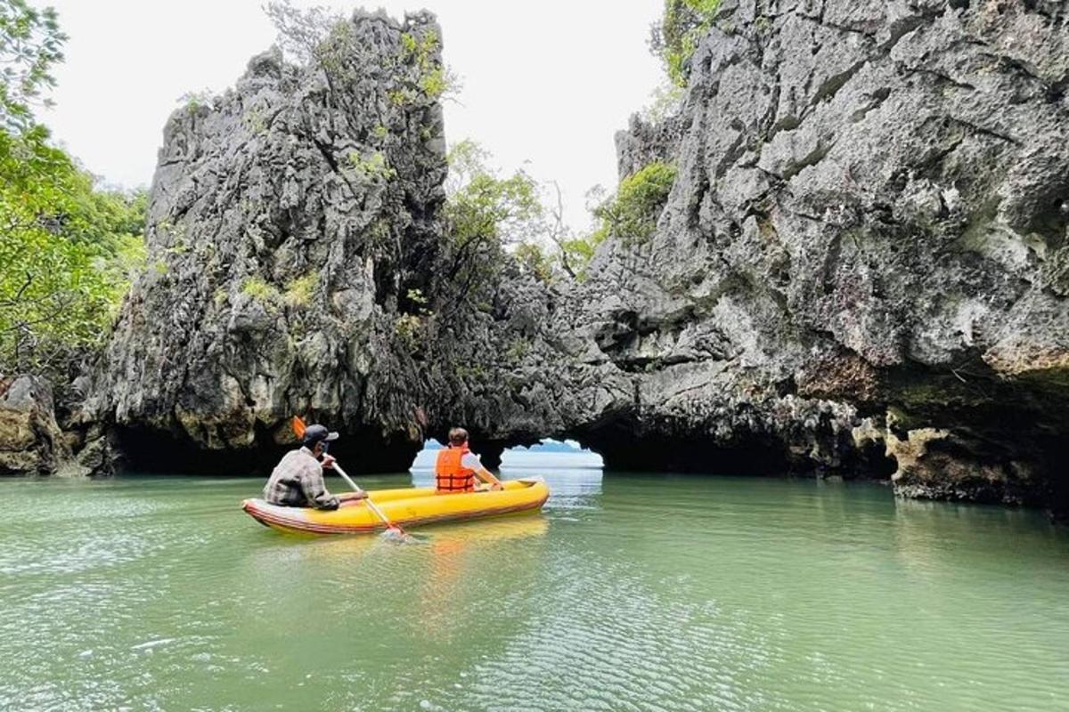 two people in a boat in a cave in the water