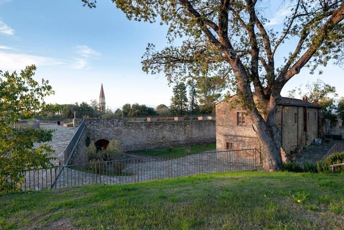 an old building with a fence and a tree