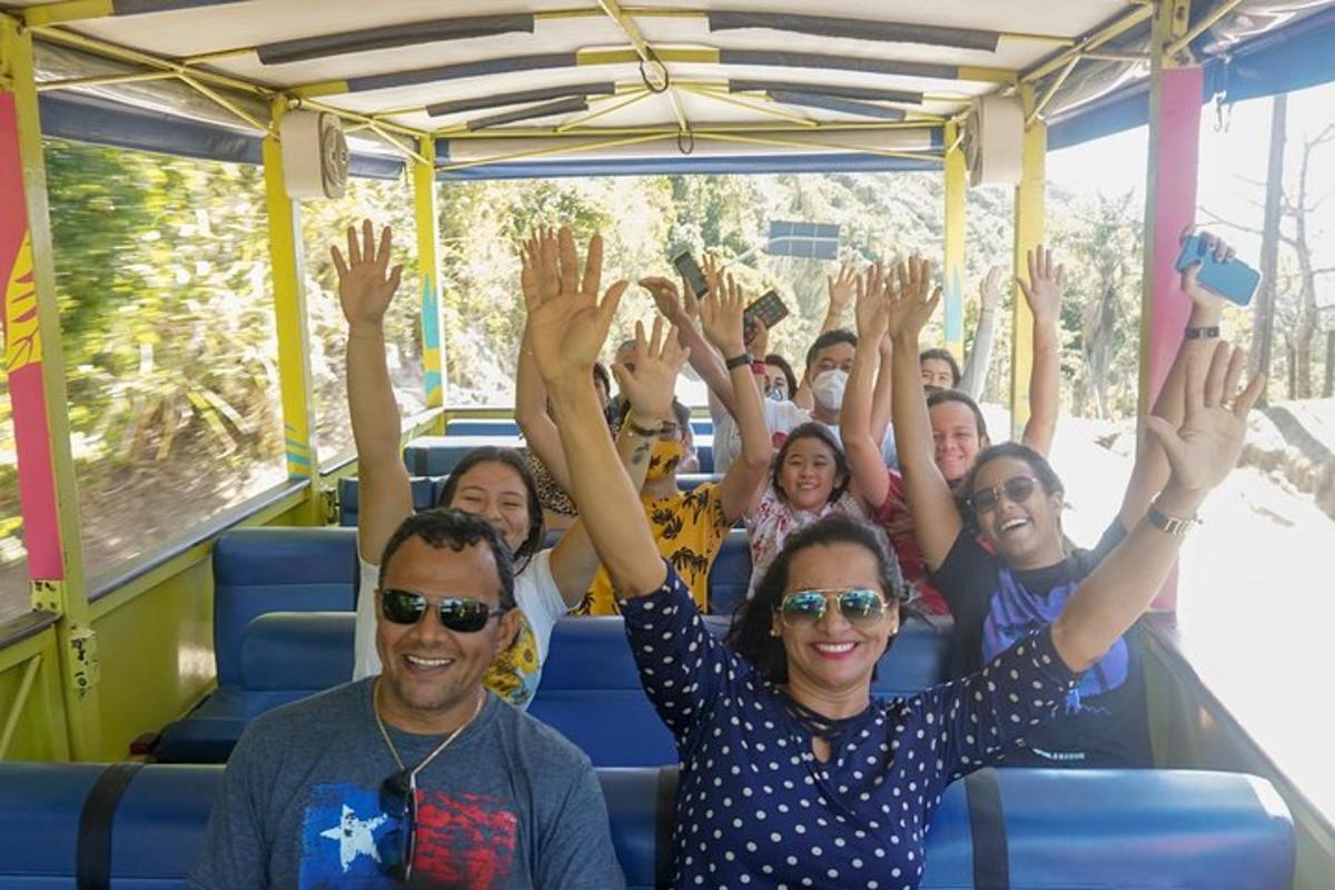 a group of people on a bus with their hands in the air