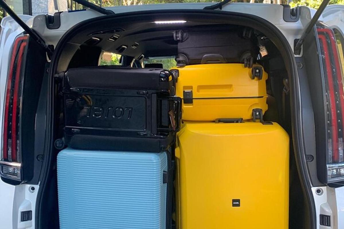 an open trunk of a vehicle with suitcases