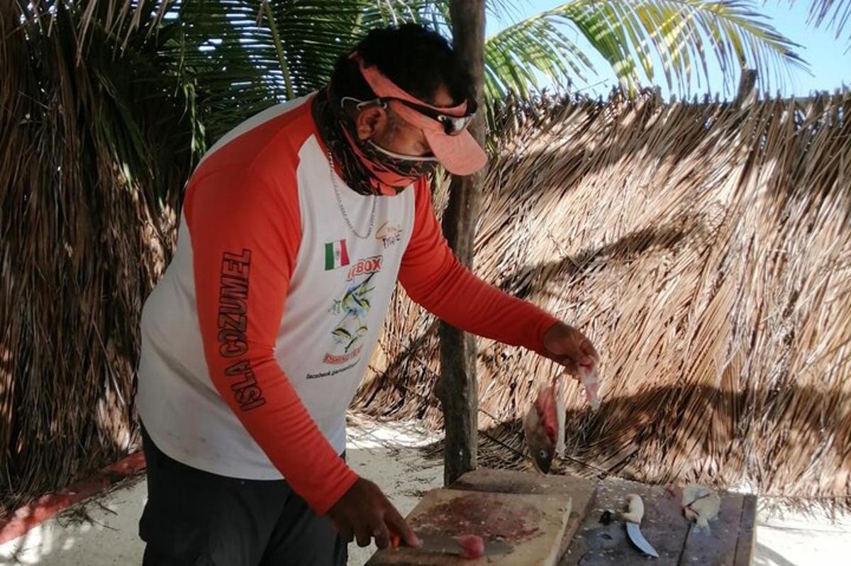 a man cooking food on top of a grill