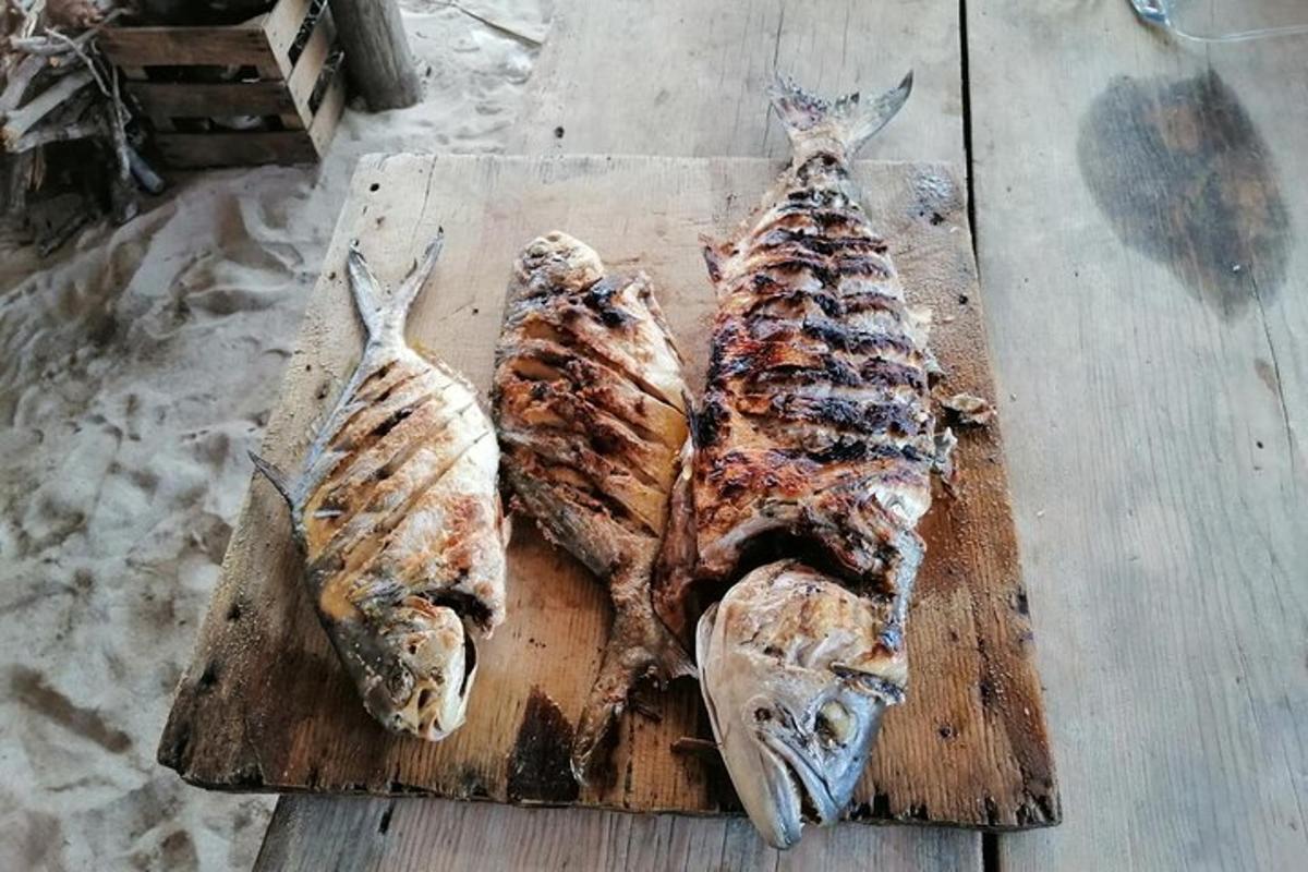 three pieces of fish sitting on a cutting board