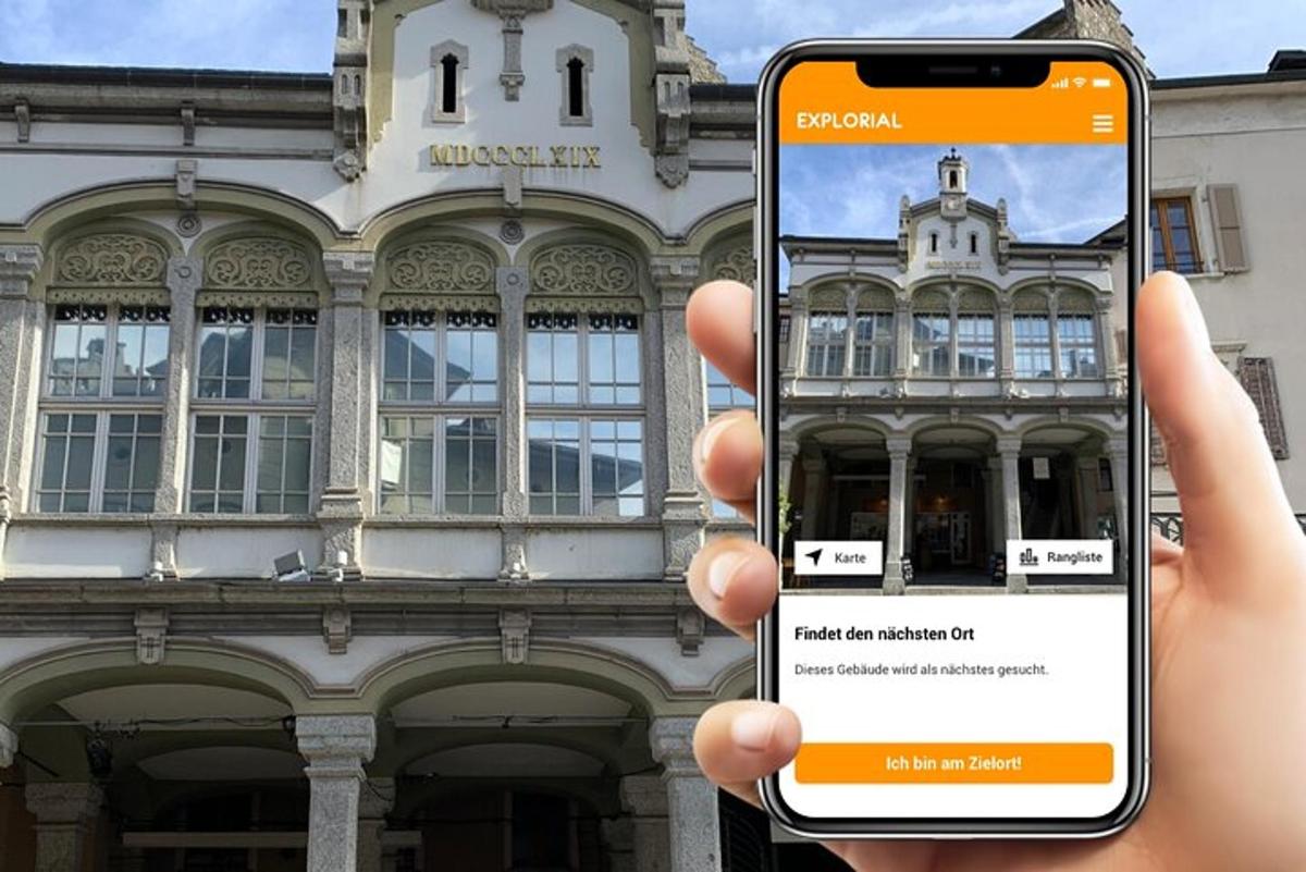 a person holding a cell phone in front of a building