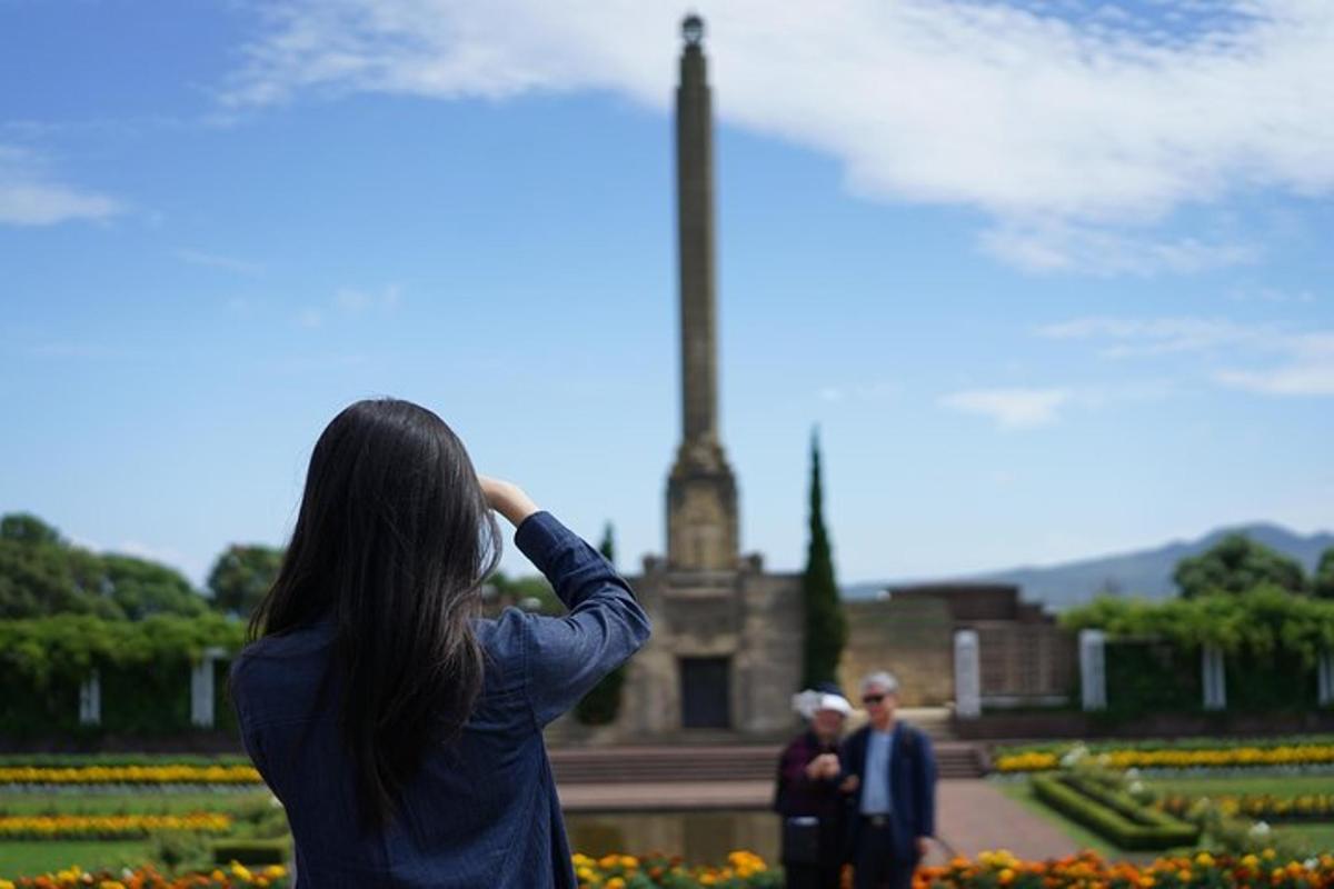 a woman is taking a picture of a monument
