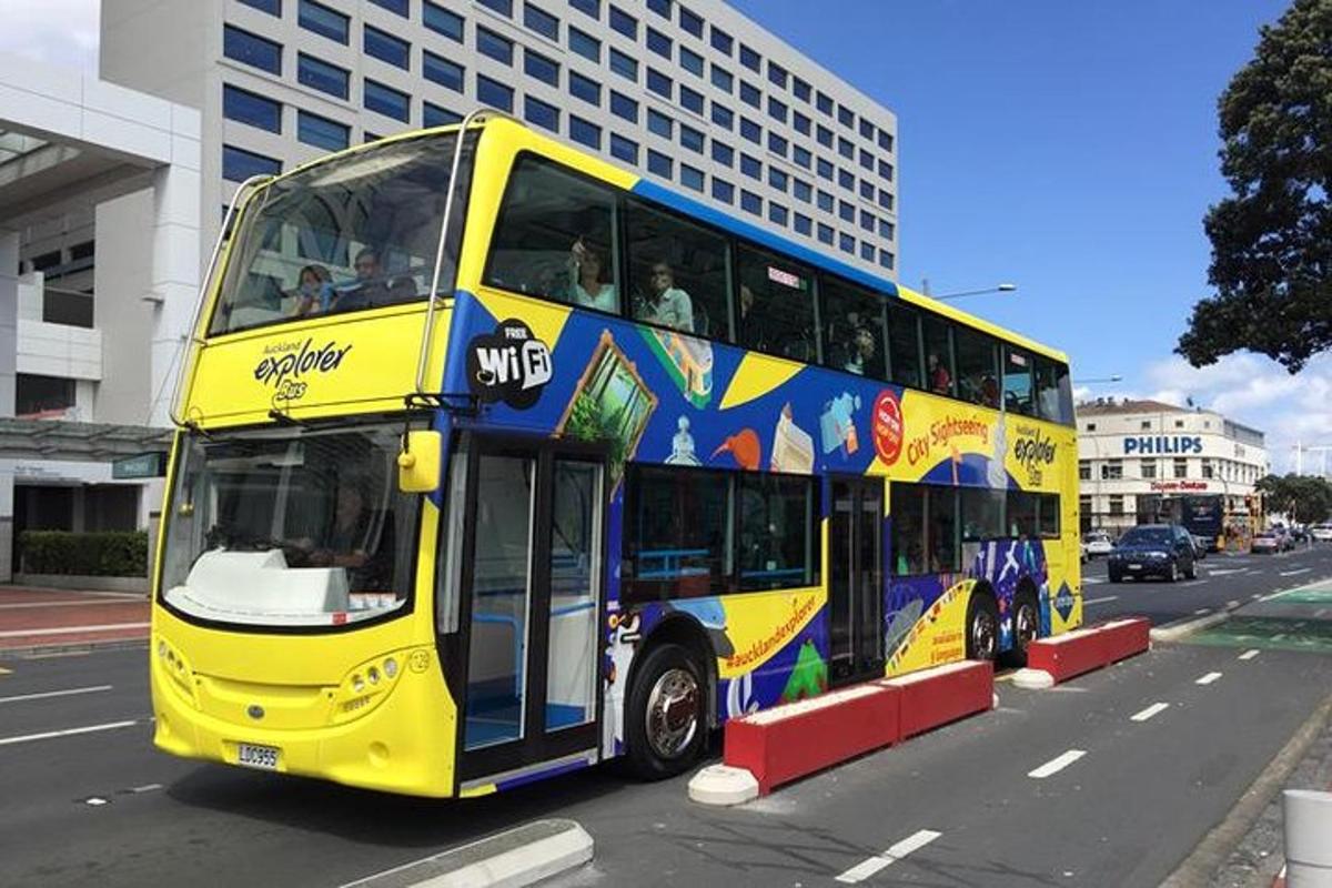 a yellow double decker bus driving down a street