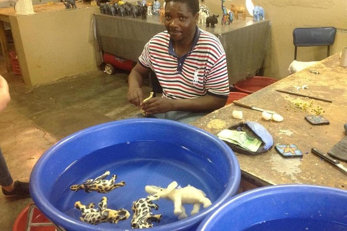 a man sitting at a table with a bowl of toy animals