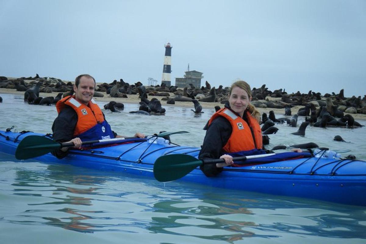 a man and a woman in a kayak on the water