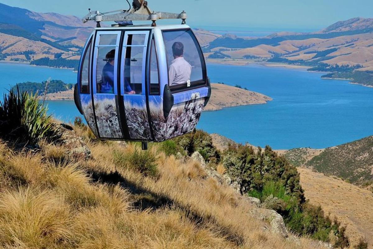 a cable car with people riding on a hill