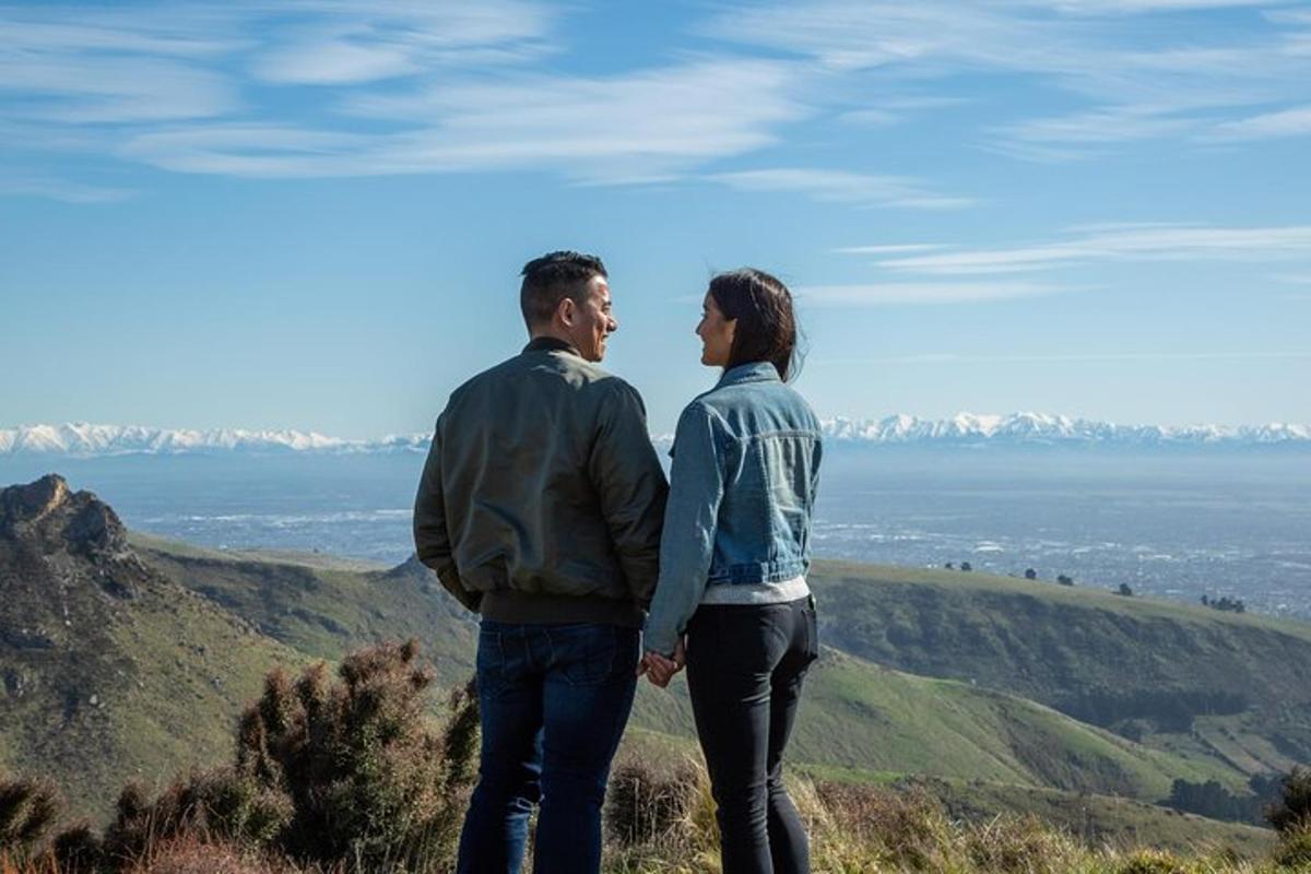 a man and a woman standing on top of a mountain