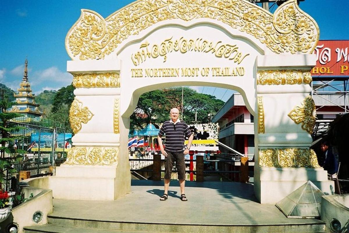 a man standing in front of an arch at a amusement park