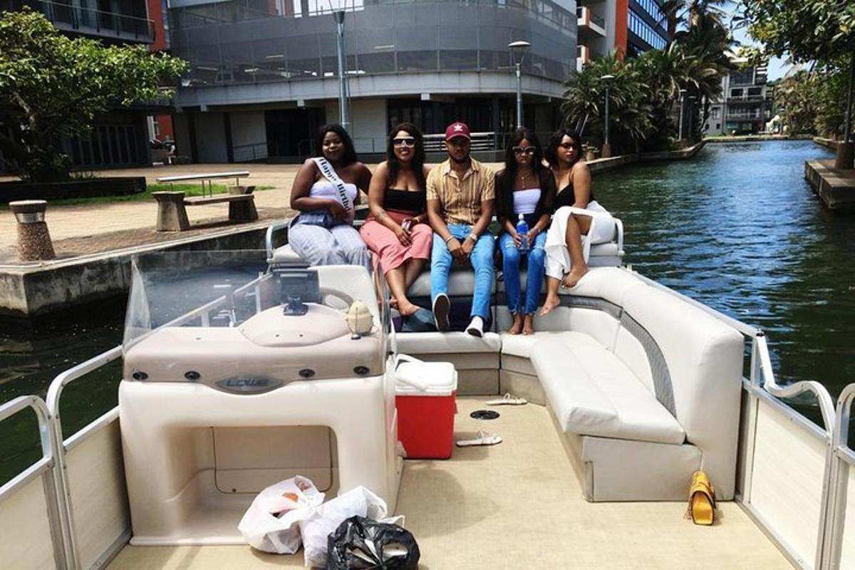 a group of people sitting on a boat in the water