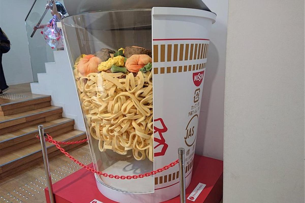 a drink container filled with noodles and other foods