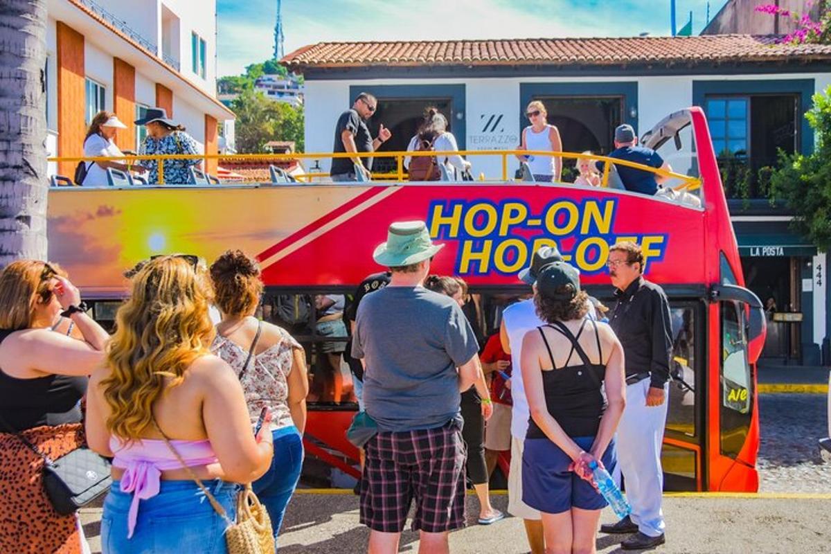 a group of people standing in front of a double decker bus