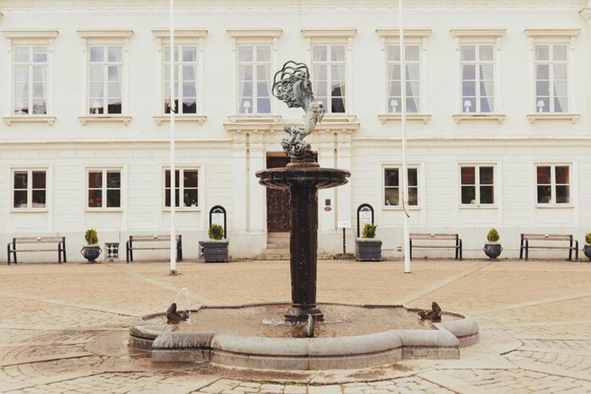 a fountain in a courtyard in front of a building