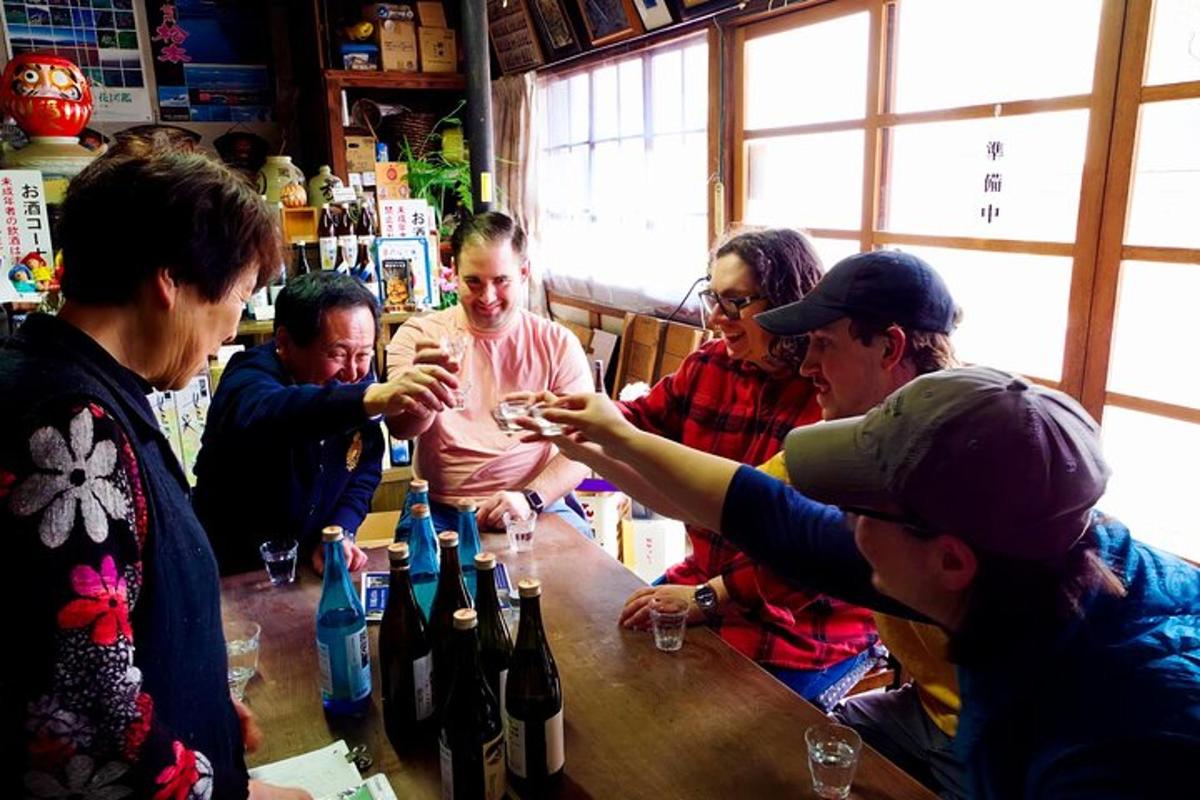 a group of people standing around a bar with wine bottles