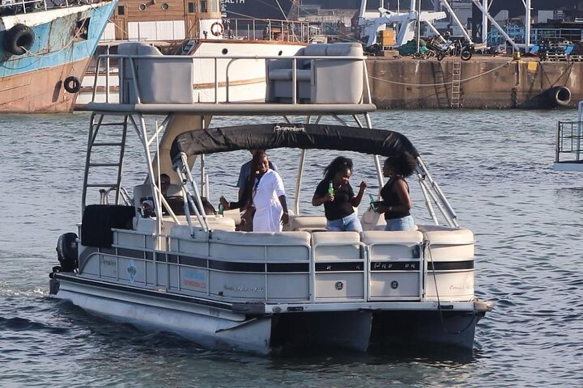a group of people on a pontoon boat in the water