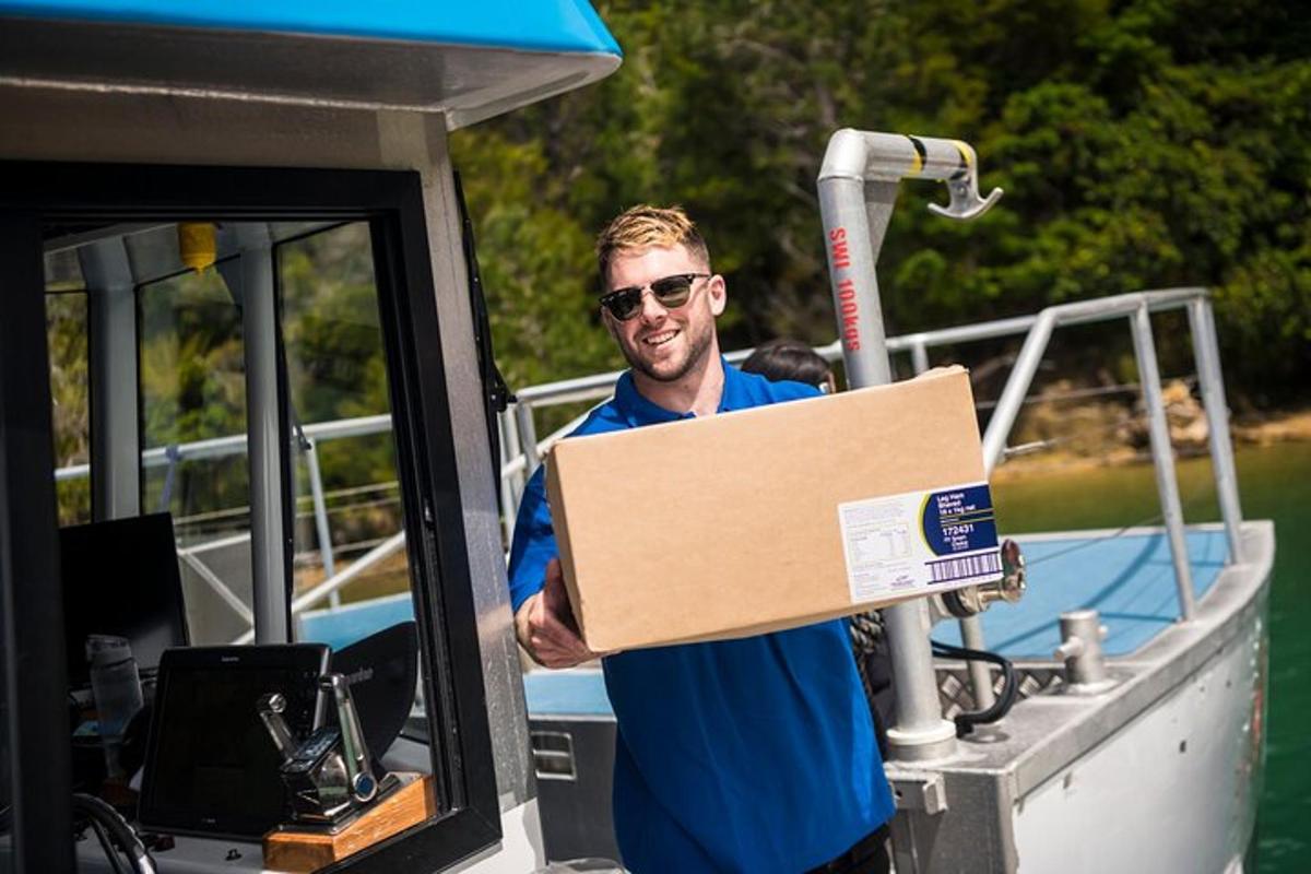 a man holding a box on a boat