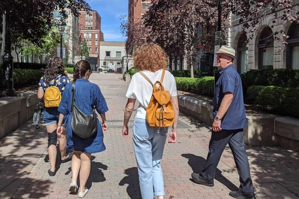 a group of people walking down a sidewalk