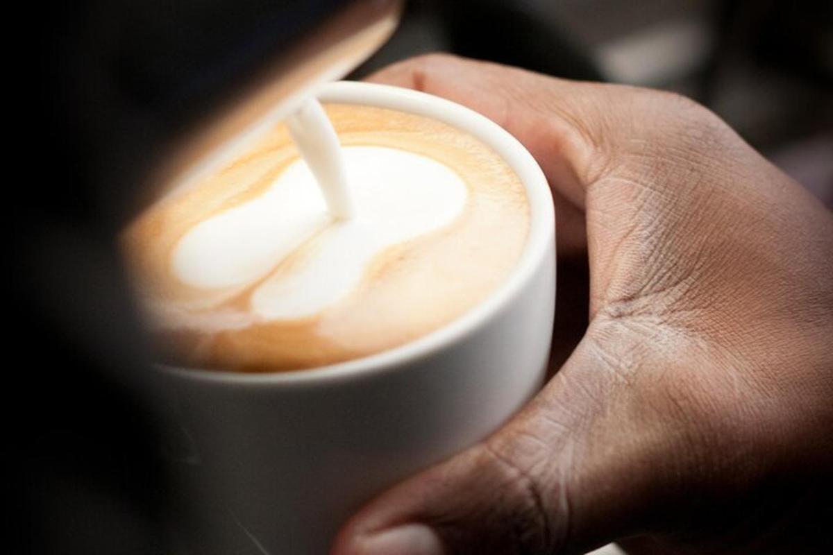 a hand is holding a cup of coffee
