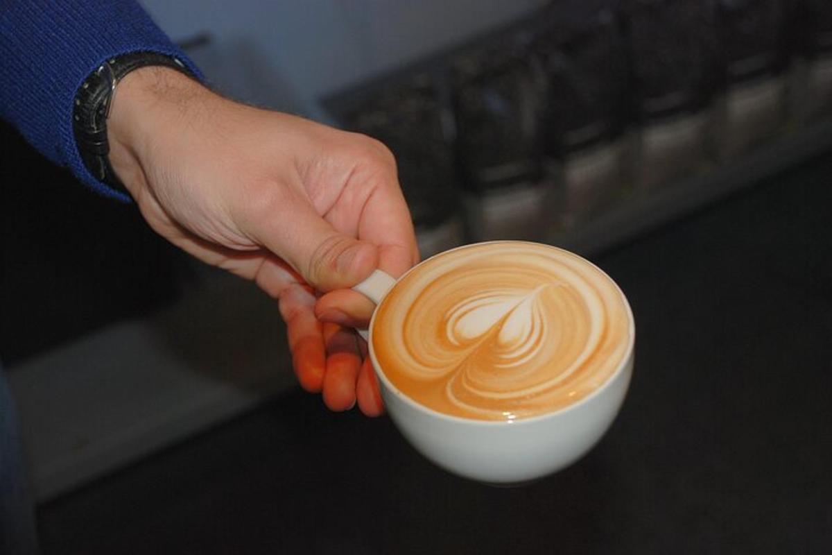o persoană ține o ceașcă de cafea