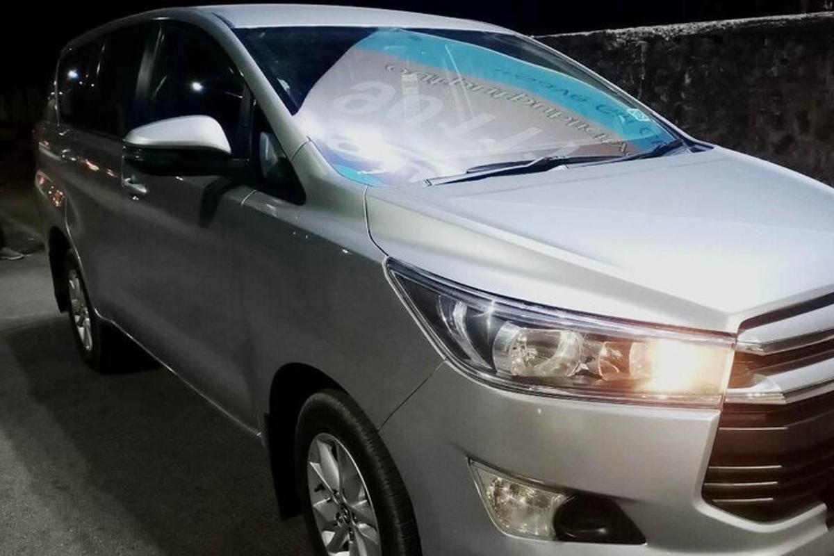 a silver car is parked on the street