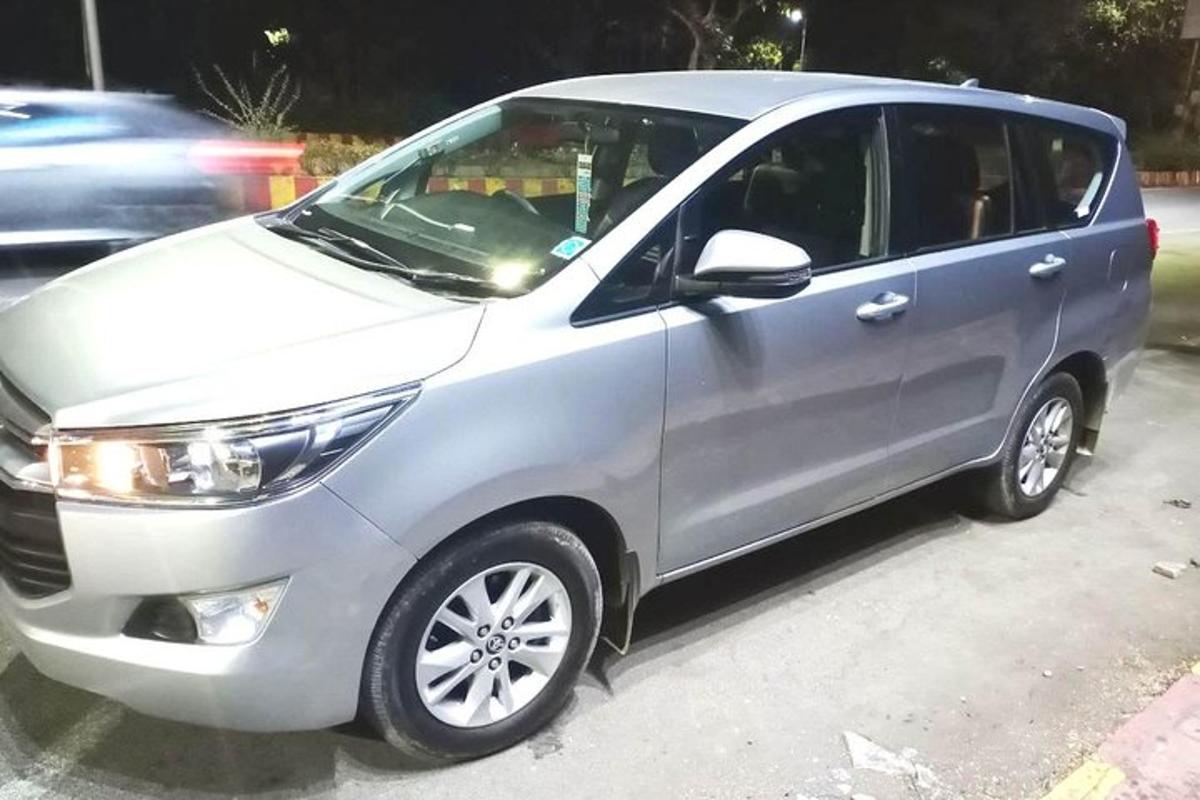 a silver minivan parked in a parking lot