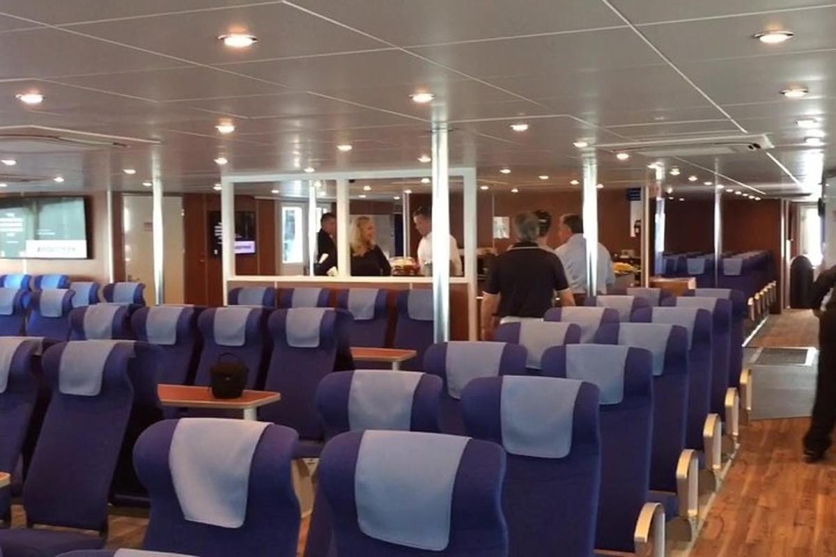 a room with blue and white chairs on a cruise ship