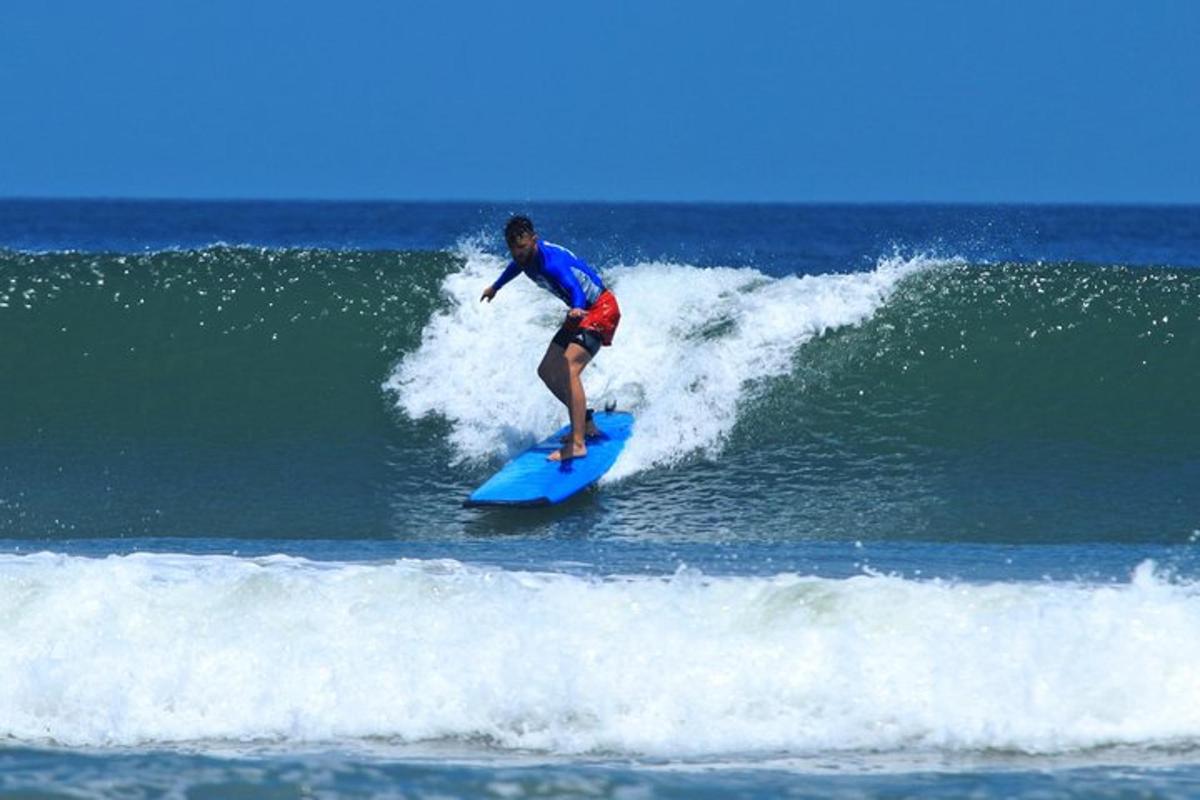 a man riding a wave on a surfboard in the ocean