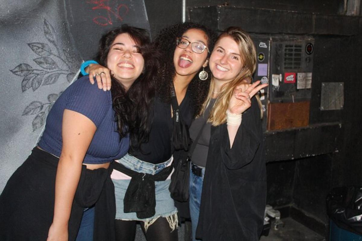three women standing next to each other posing for a picture
