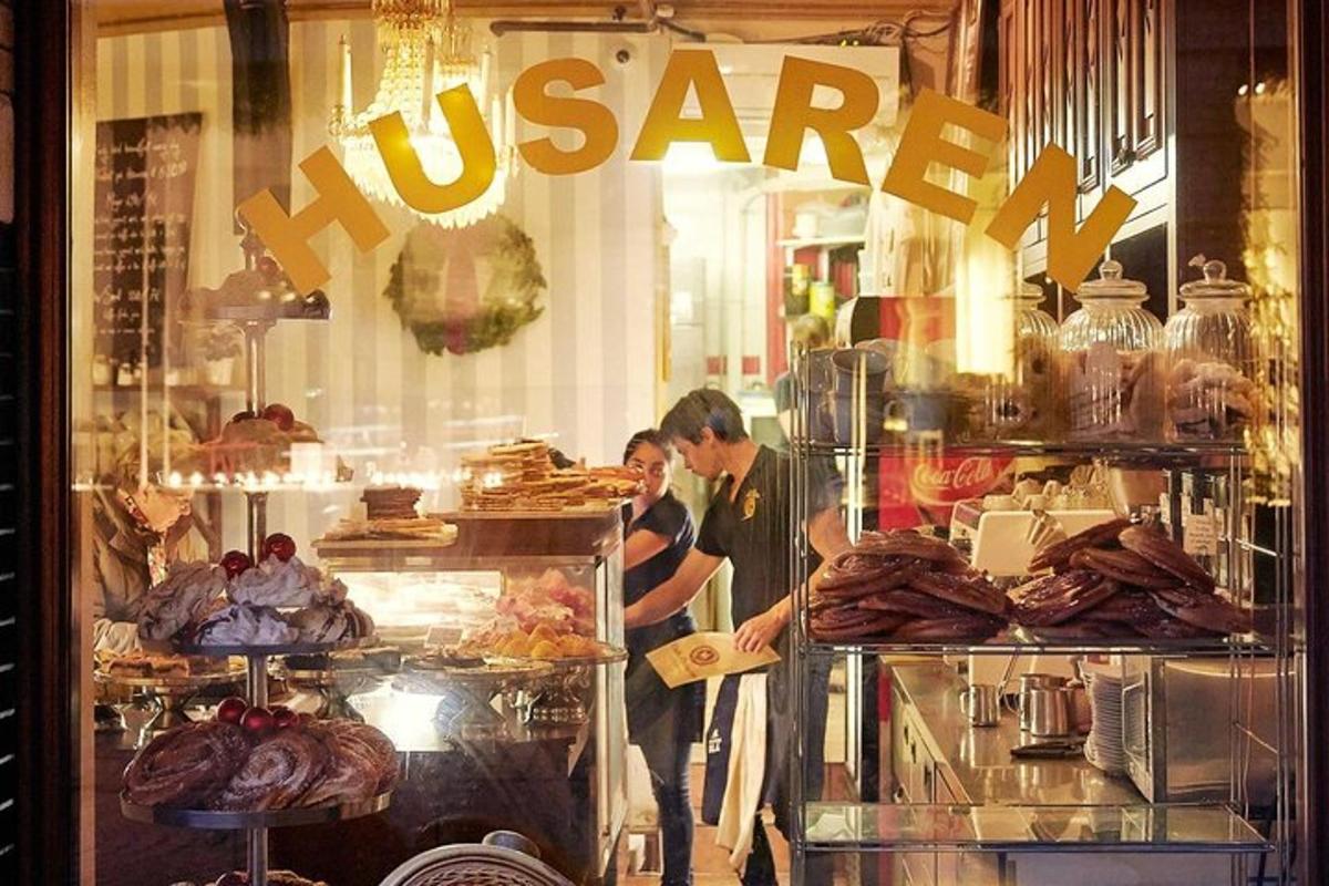 a man and a woman standing in a bakery window