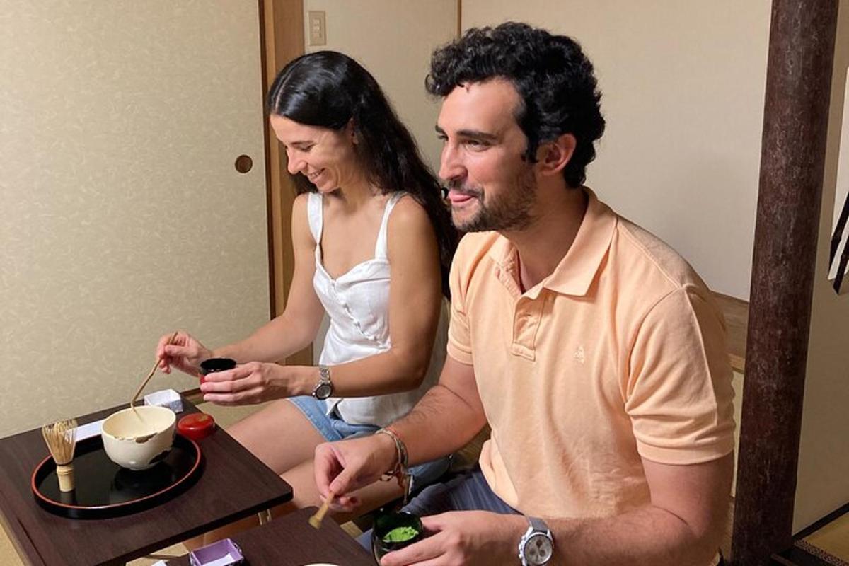 a man and woman sitting at a table eating food