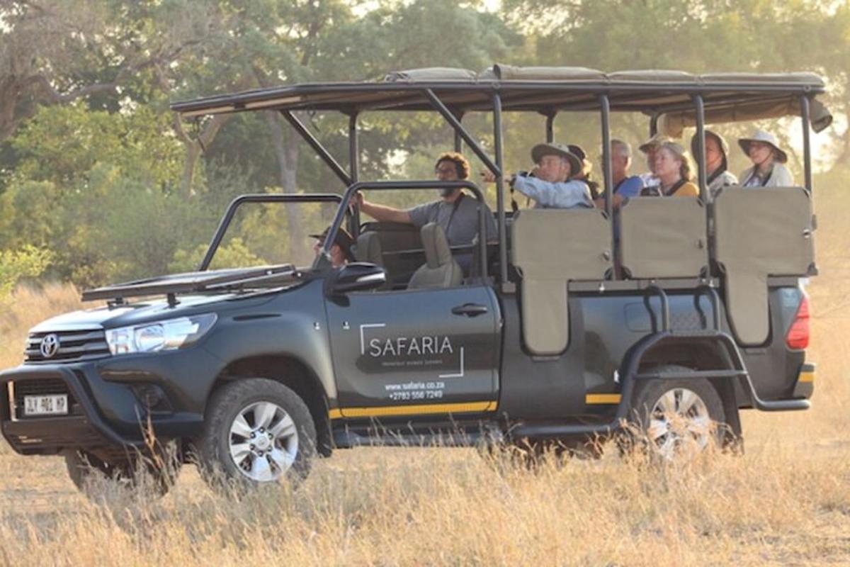 a group of people riding in a safari vehicle