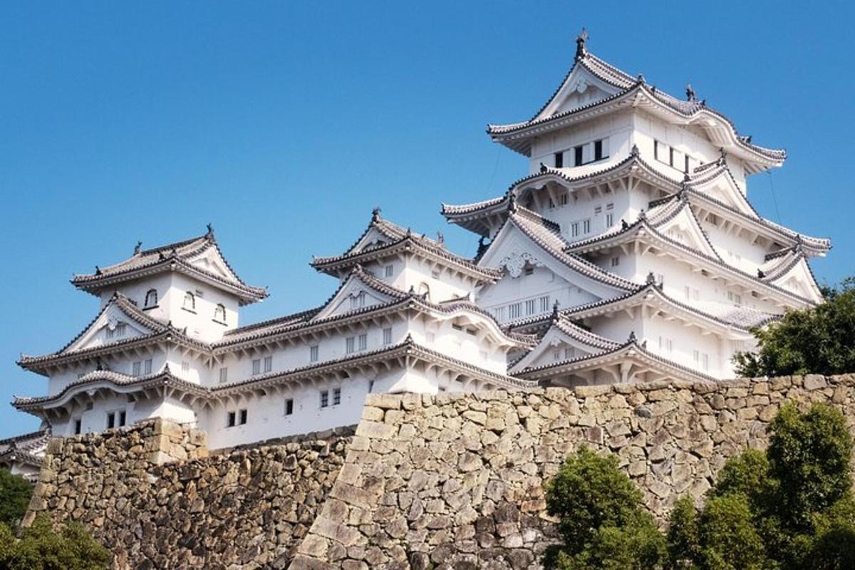 a large white building on top of a stone wall