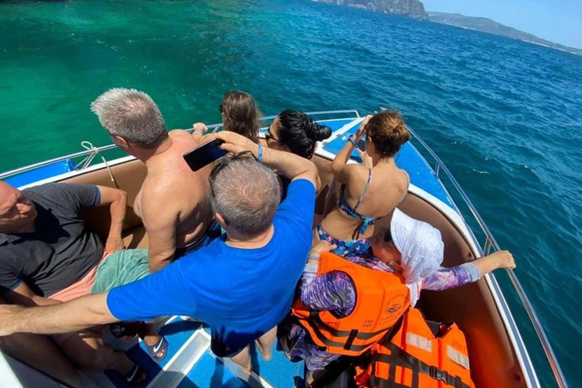 a group of people on a boat in the water