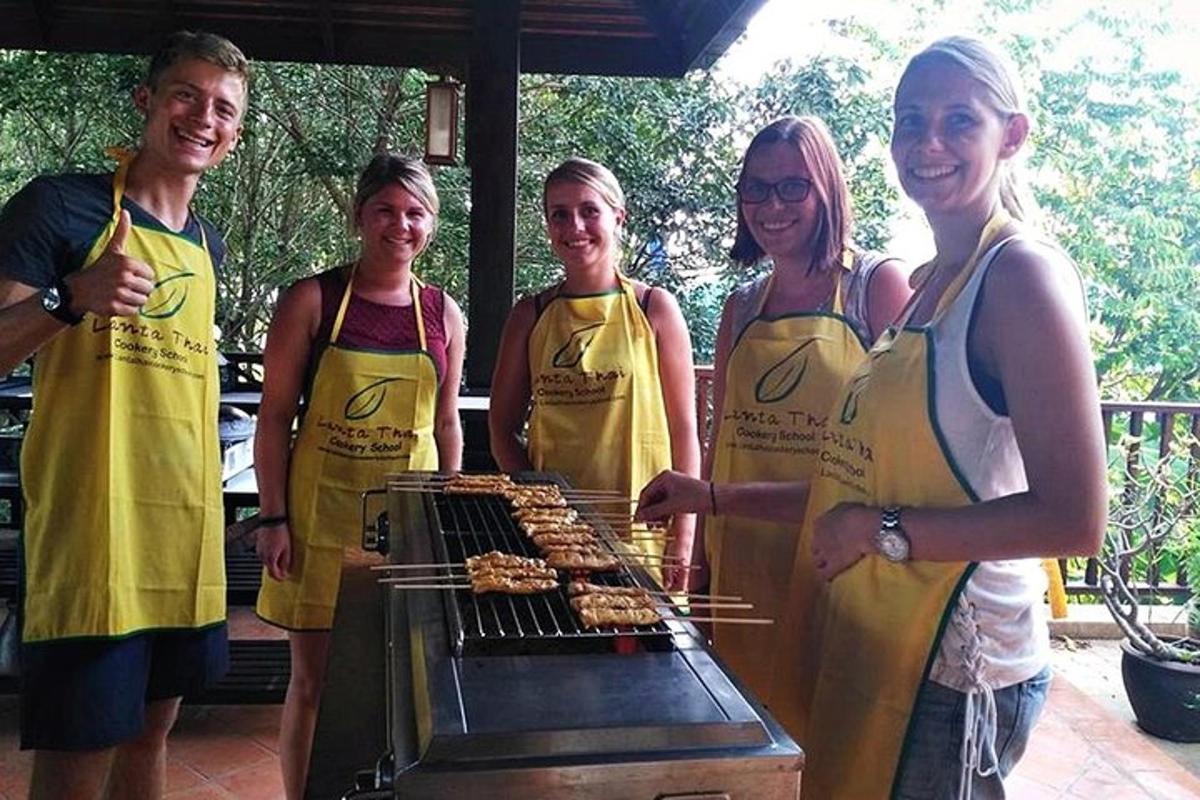 a group of people cooking food on a grill