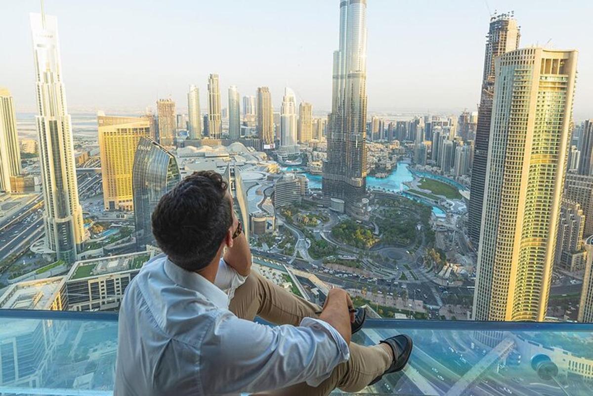 a man standing on top of a skyscraper looking at a city