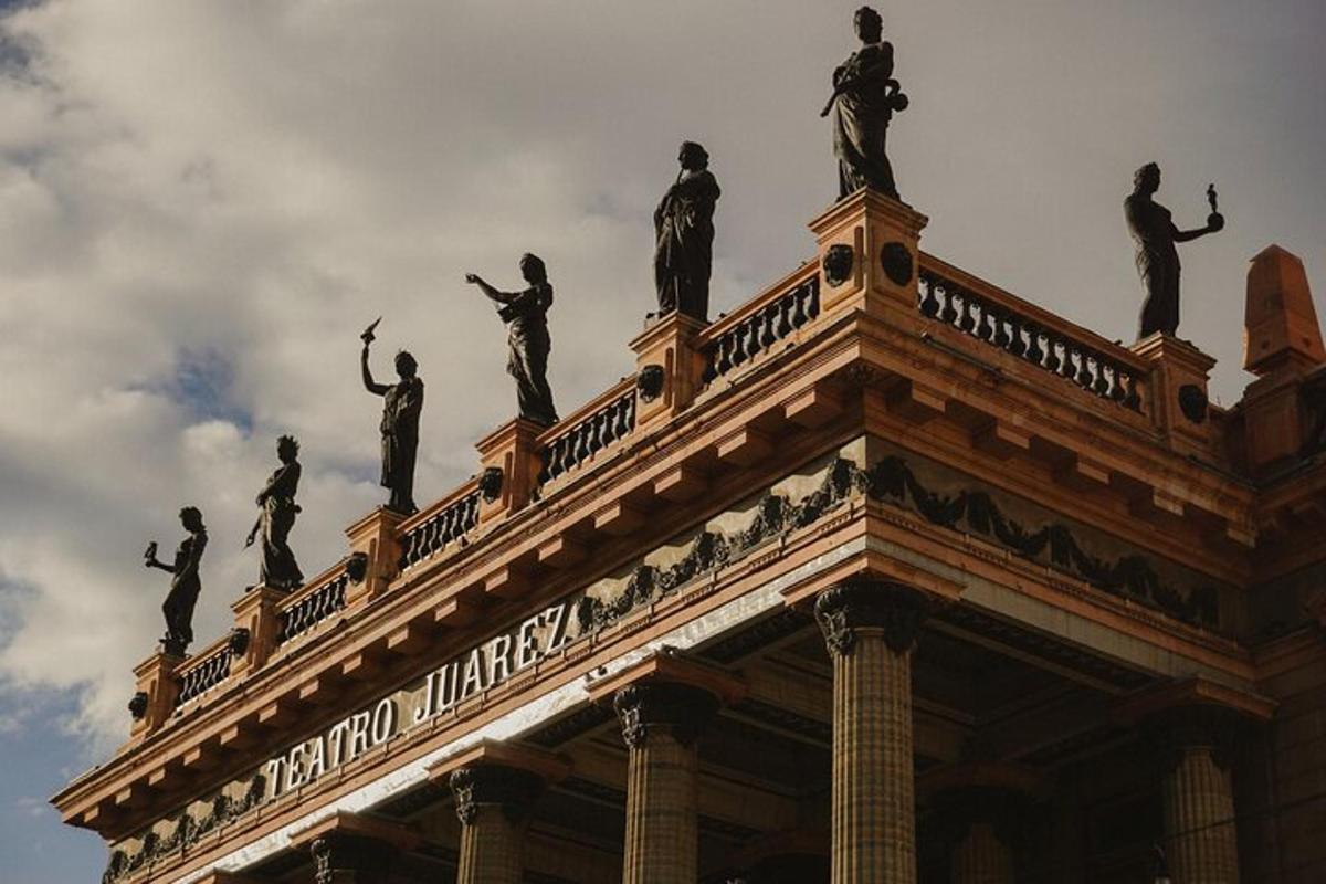 a bunch of statues on top of a building