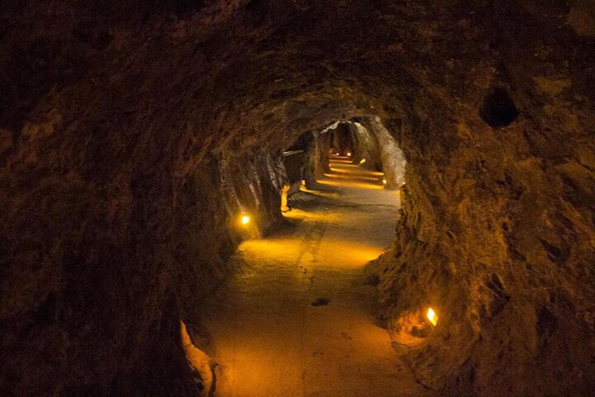 a dark tunnel with lights in the end of it