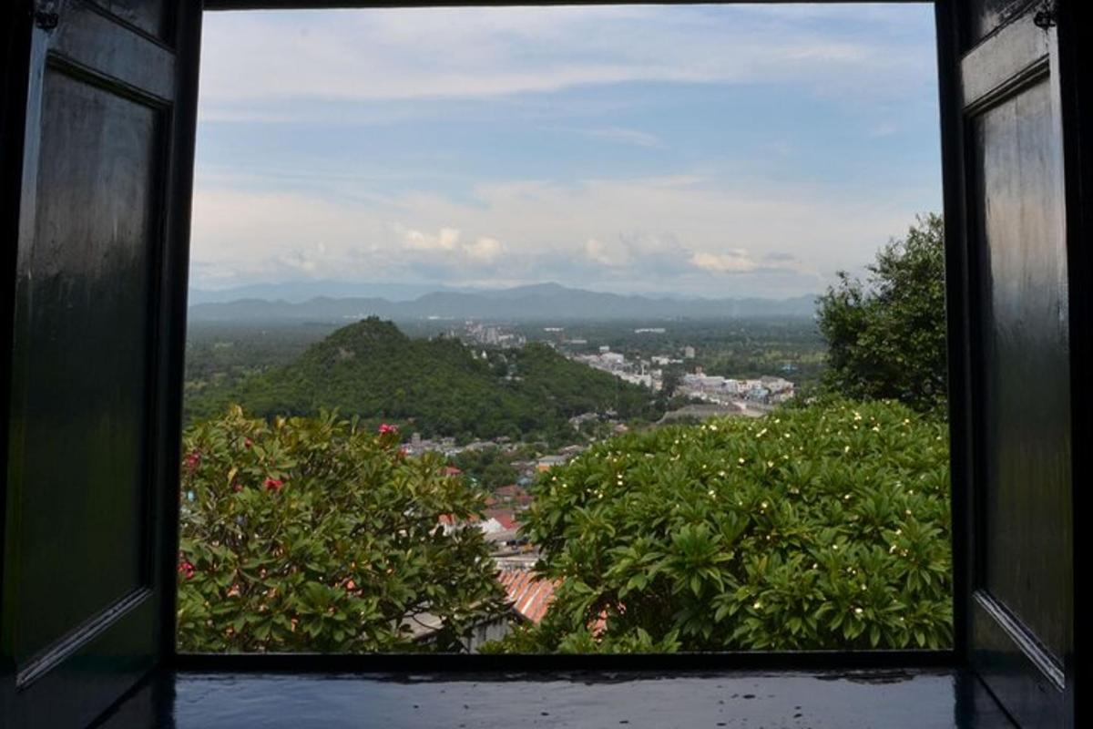 a window with a view of a city with trees