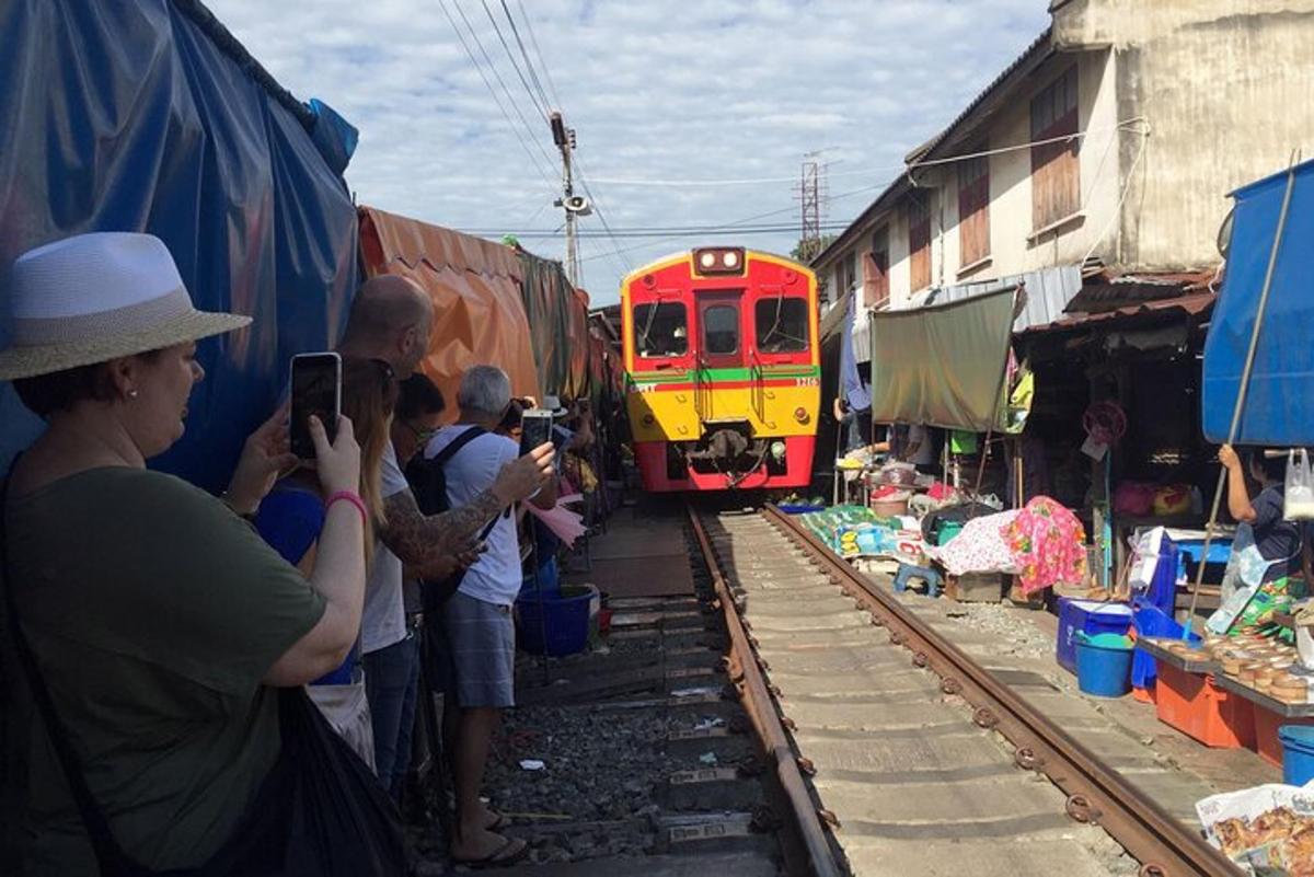 a group of people taking a picture of a train