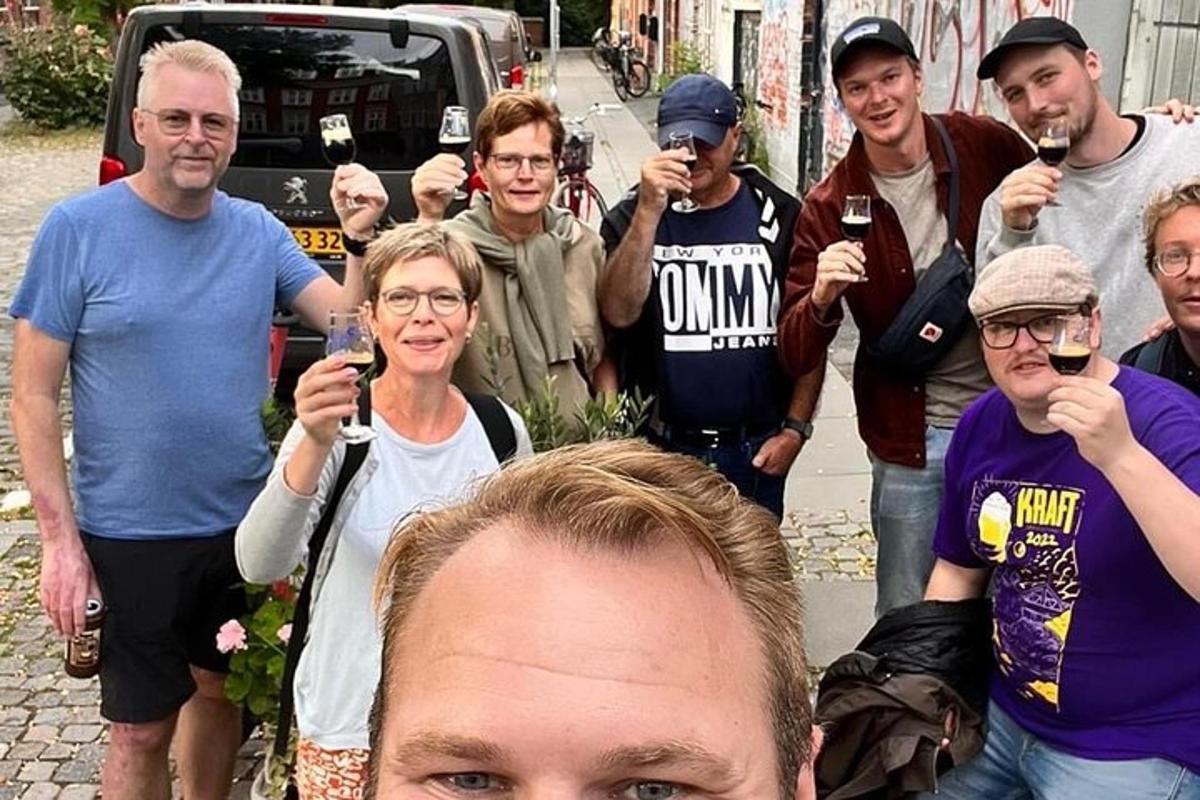 a group of people drinking wine and posing for a picture
