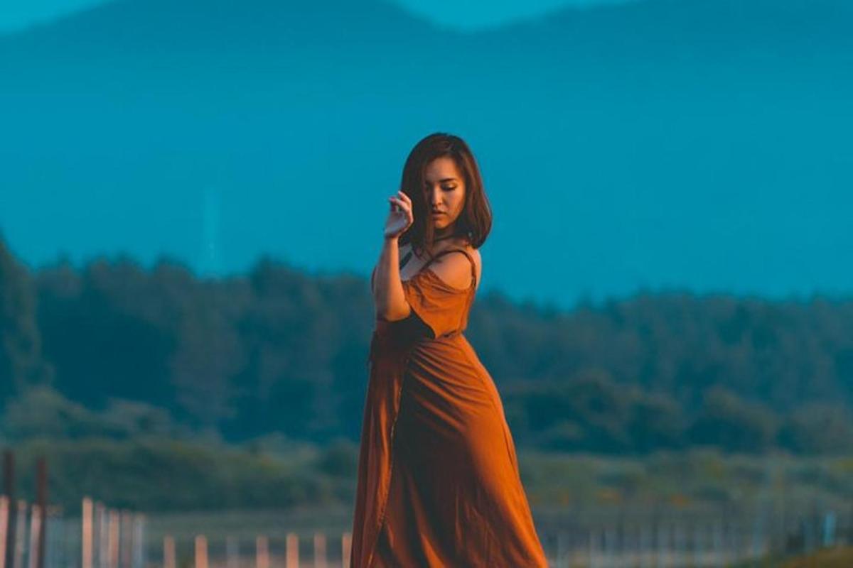 一位身穿橙色连衣裙的女士正在打电话