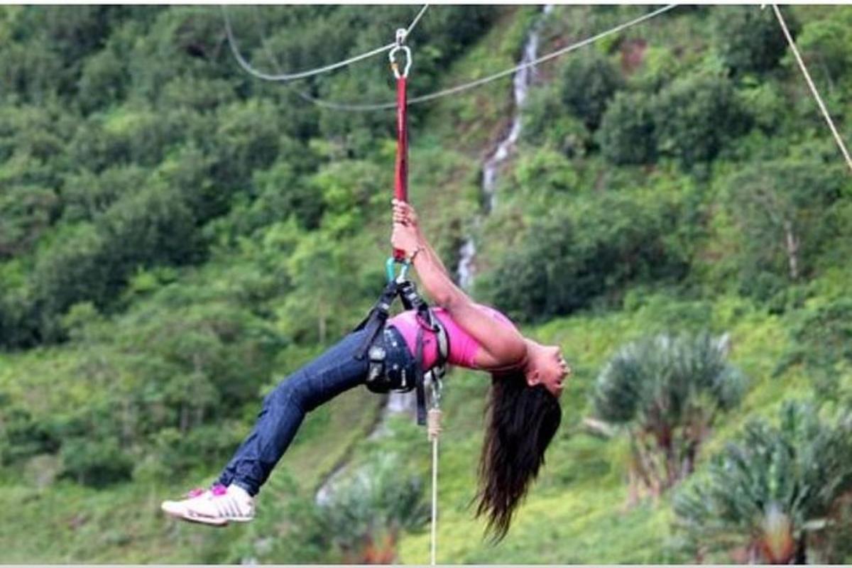 Una mujer colgada de una cuerda en una tirolesa