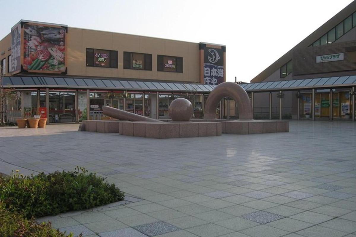a building with a sculpture in the middle of a courtyard
