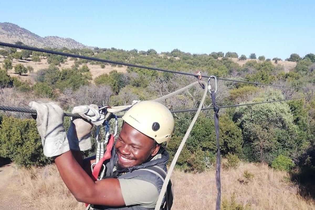 a man in a helmet on a zip line
