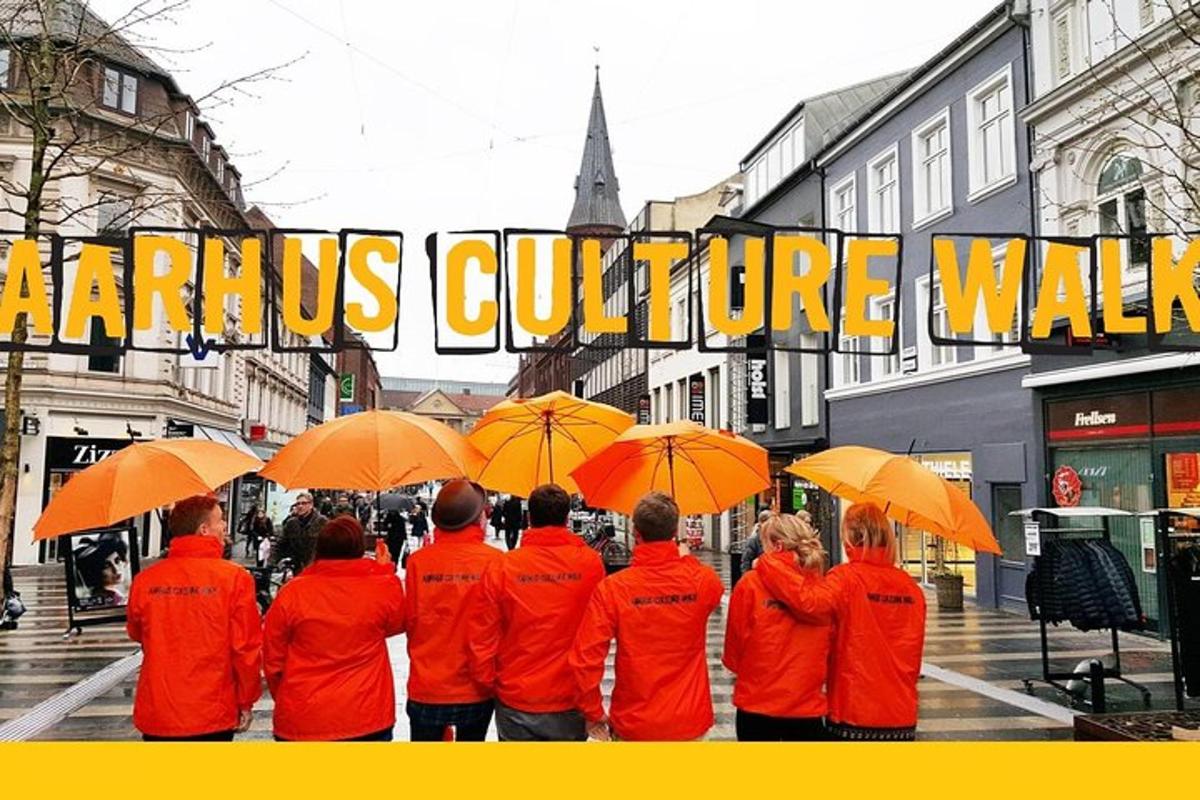 a group of people in orange jackets holding umbrellas
