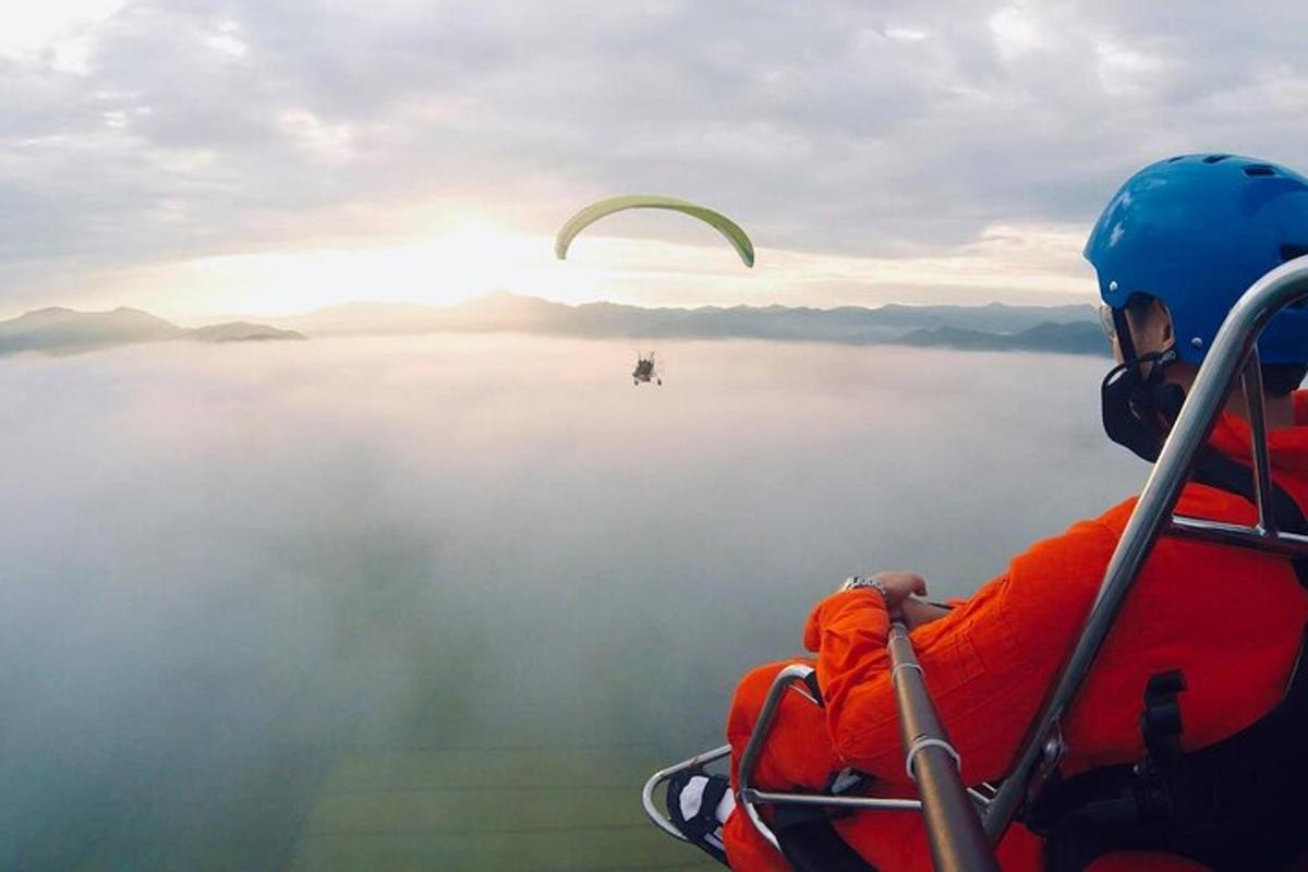oseba, ki leti z jadralnim padalom nad vodno površino