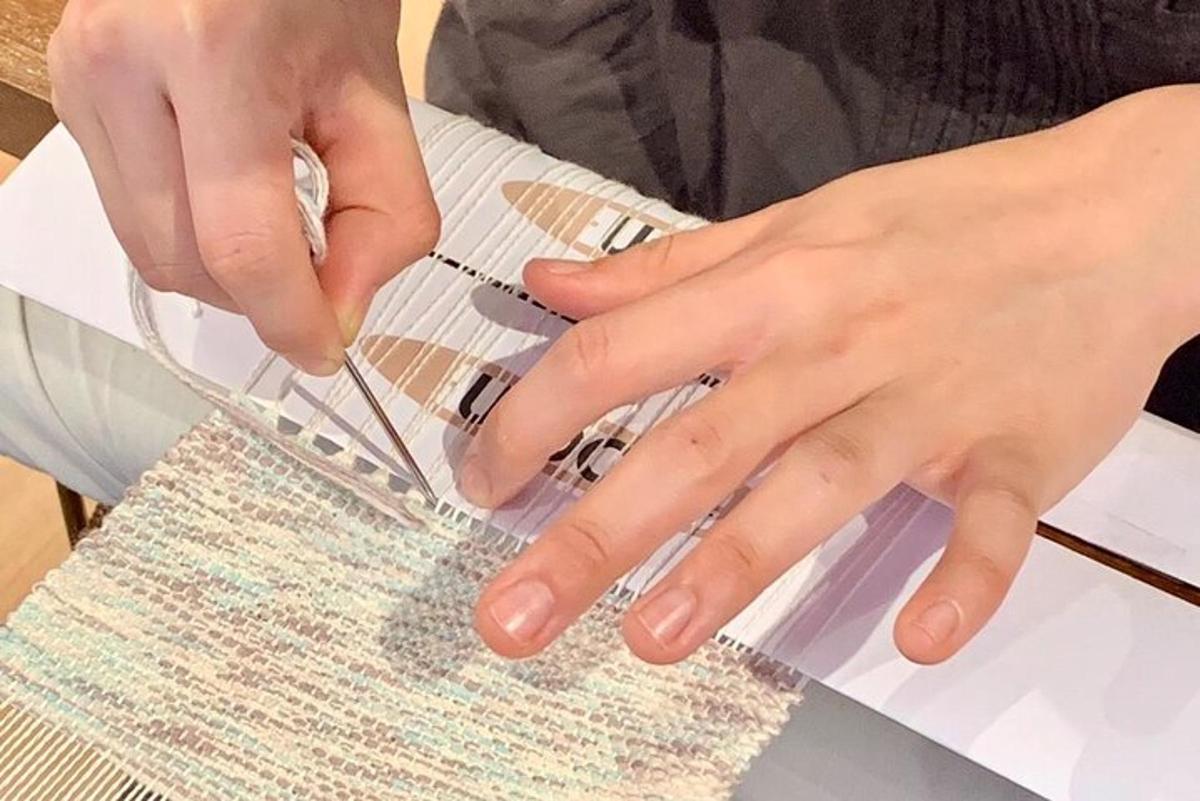 a person cutting a piece of paper with a machine