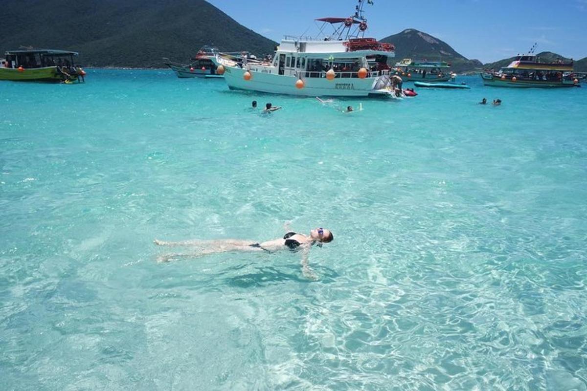 a person swimming in the ocean with a boat