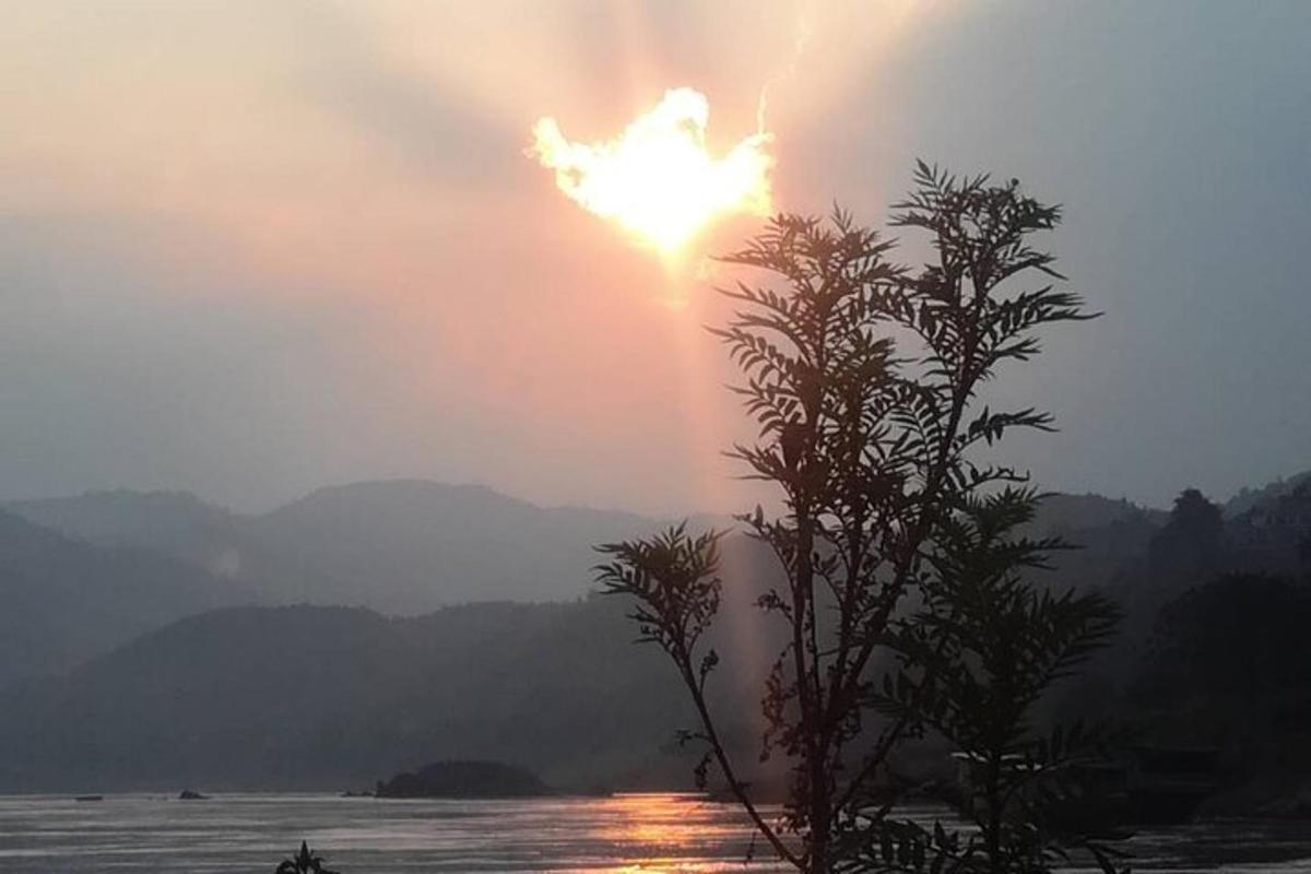 a sun is setting over a body of water